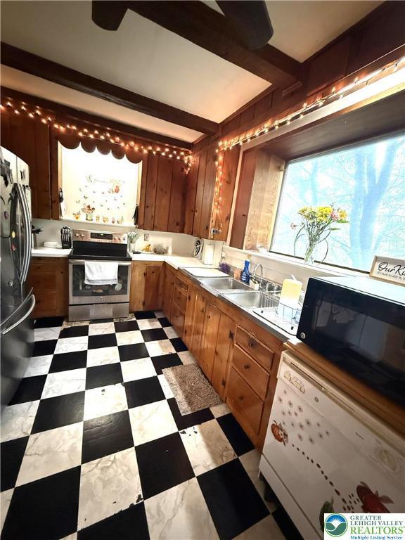 204 Analomink St, East Stroudsburg, PA 18301 - kitchen with appliances with stainless steel finishes, light countertops, light flooring, brown cabinetry, and a sink