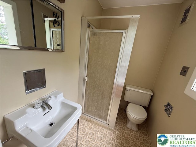 204 Analomink St, East Stroudsburg, PA 18301 - bathroom with toilet, a stall shower, a sink, and tile patterned floors