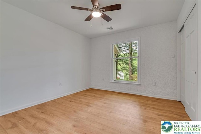 711 E Center St, Nesquehoning Borough, PA 18240 - unfurnished bedroom featuring baseboards, light wood-style floors, a closet, and a ceiling fan