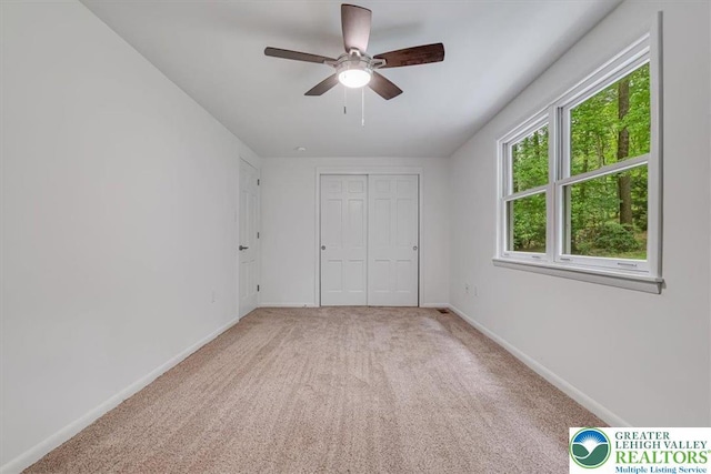 711 E Center St, Nesquehoning Borough, PA 18240 - unfurnished bedroom featuring light carpet, baseboards, a closet, and a ceiling fan
