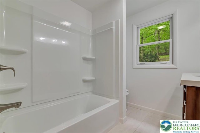711 E Center St, Nesquehoning Borough, PA 18240 - full bath featuring toilet, vanity, baseboards, tile patterned floors, and shower / tub combination