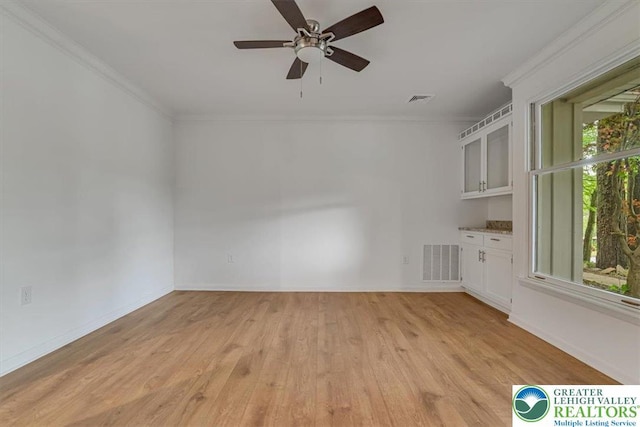 711 E Center St, Nesquehoning Borough, PA 18240 - unfurnished room with crown molding, light wood-type flooring, ceiling fan, and baseboards