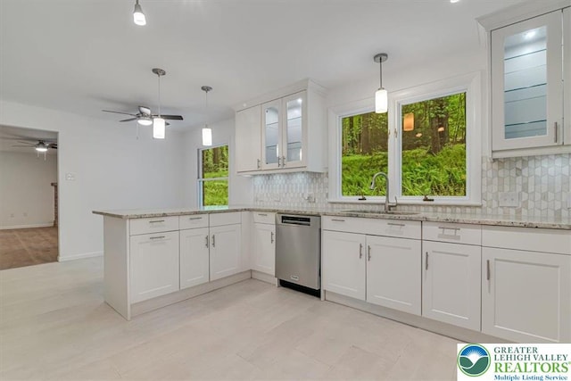 711 E Center St, Nesquehoning Borough, PA 18240 - kitchen featuring stainless steel dishwasher, a sink, a peninsula, a ceiling fan, and decorative backsplash