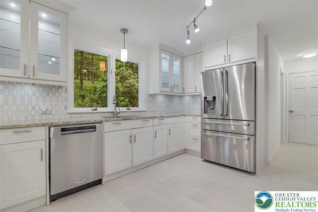 711 E Center St, Nesquehoning Borough, PA 18240 - kitchen with stainless steel appliances, a sink, backsplash, white cabinetry, and light stone countertops