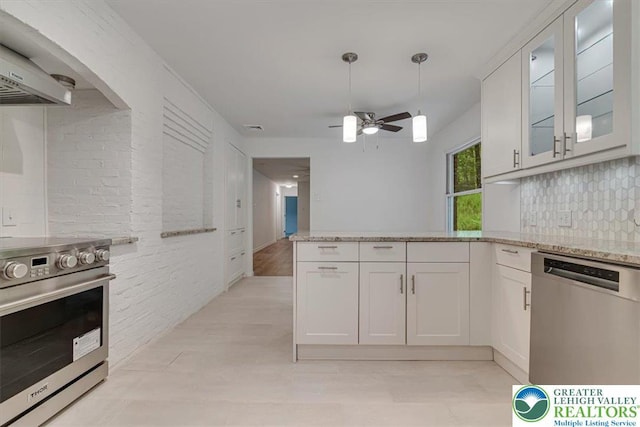 711 E Center St, Nesquehoning Borough, PA 18240 - kitchen featuring appliances with stainless steel finishes, ventilation hood, white cabinetry, and light stone countertops