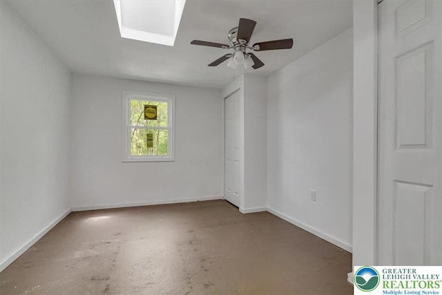 711 E Center St, Nesquehoning Borough, PA 18240 - unfurnished room featuring concrete floors, baseboards, ceiling fan, and a skylight