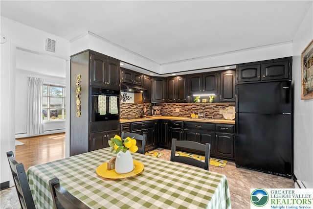 929 Webster Ave, Allentown City, PA 18103 - kitchen featuring black appliances, backsplash, light countertops, dark brown cabinetry, and under cabinet range hood