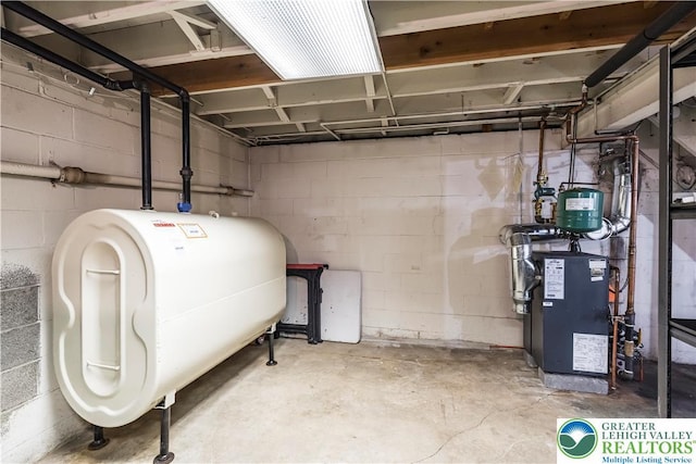 929 Webster Ave, Allentown City, PA 18103 - unfinished basement with oil tank, concrete block wall, and a heating unit