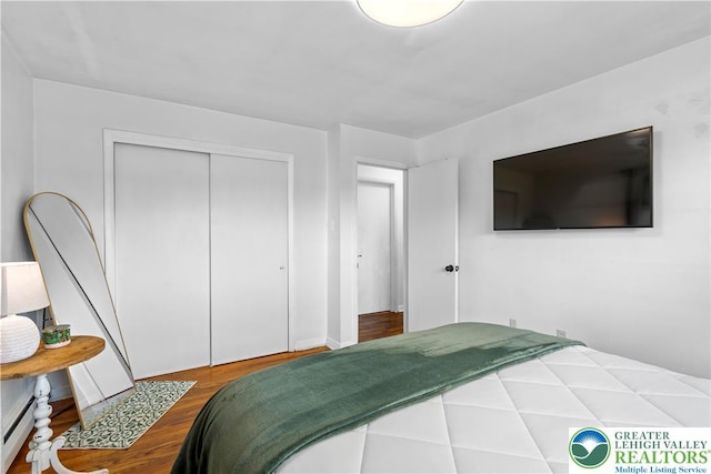 929 Webster Ave, Allentown City, PA 18103 - bedroom with a baseboard radiator, a closet, and wood finished floors