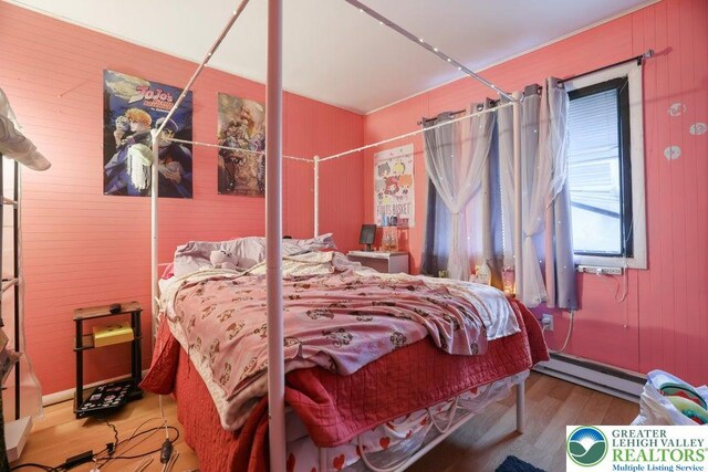 4754 Brentwood Dr, Tobyhanna Twp, PA 18466 - bedroom with a baseboard radiator, wood finished floors, and wood walls