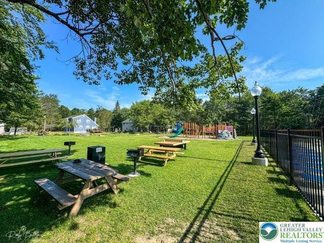 4754 Brentwood Dr, Tobyhanna Twp, PA 18466 - surrounding community featuring a playground and view of wooded area
