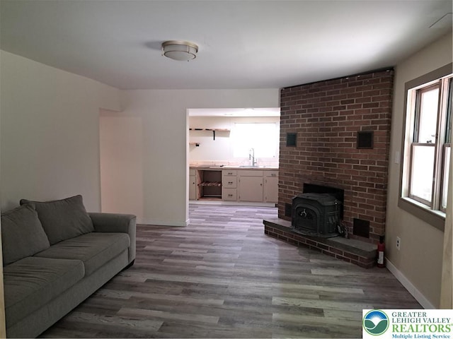 1392 Cherrylane Rd, Stroud Twp, PA 18301 - living room featuring a wood stove, healthy amount of natural light, and light wood-style floors