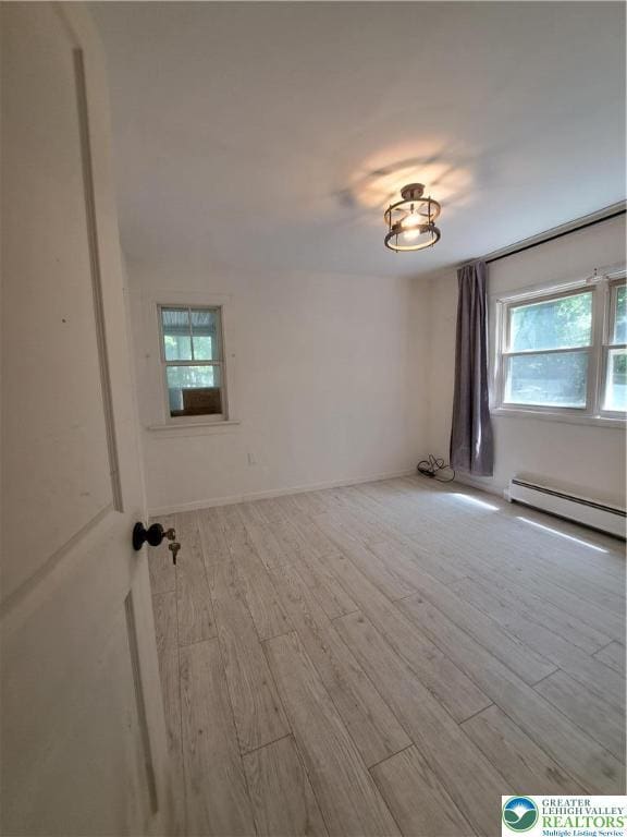 1392 Cherrylane Rd, Stroud Twp, PA 18301 - unfurnished room featuring a baseboard radiator and wood finished floors