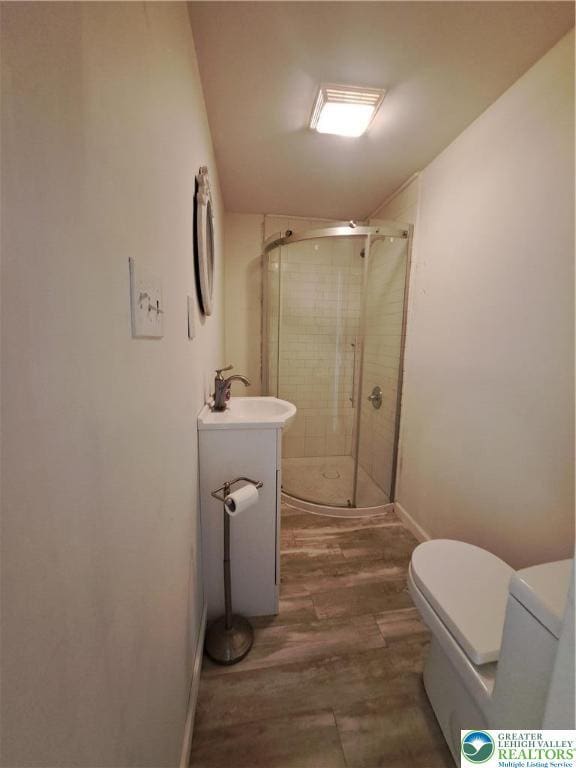 1392 Cherrylane Rd, Stroud Twp, PA 18301 - bathroom featuring toilet, a stall shower, wood finished floors, vanity, and baseboards