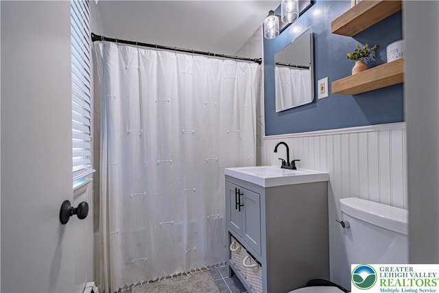 1131 28th St, Allentown City, PA 18104 - full bath with toilet, a wainscoted wall, plenty of natural light, vanity, and curtained shower