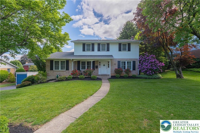1131 28th St, Allentown City, PA 18104 - traditional-style home with a front yard, brick siding, and a porch