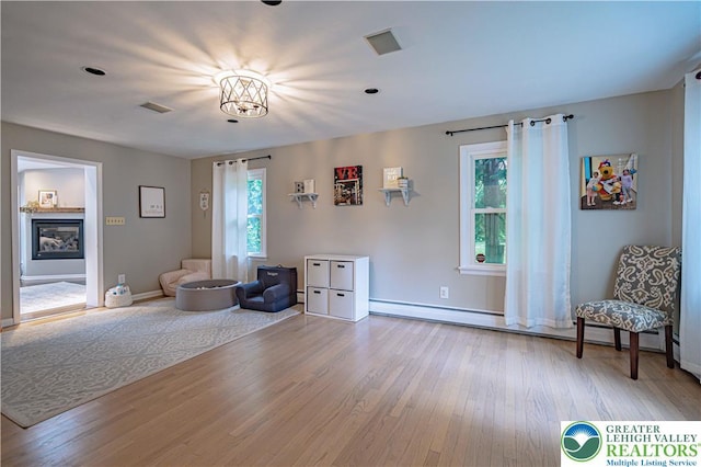 1131 28th St, Allentown City, PA 18104 - living area with wood finished floors, baseboards, and a glass covered fireplace