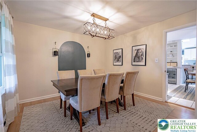 1131 28th St, Allentown City, PA 18104 - dining area featuring a chandelier, wood finished floors, wine cooler, and baseboards