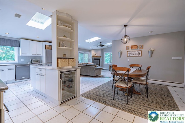 1131 28th St, Allentown City, PA 18104 - kitchen with a skylight, stainless steel dishwasher, beverage cooler, tasteful backsplash, and healthy amount of natural light