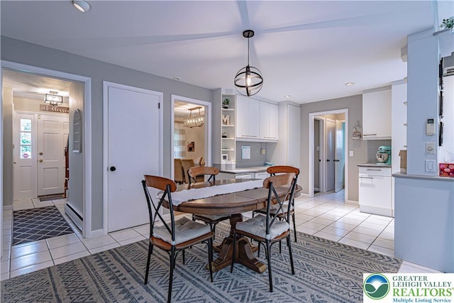 1131 28th St, Allentown City, PA 18104 - dining area with light tile patterned floors, a chandelier, and baseboards
