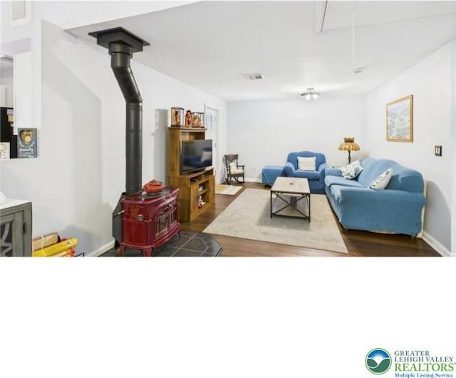108 Abbey Ln, Lehman Twp, PA 18302 - living area featuring attic access, a wood stove, and dark wood finished floors