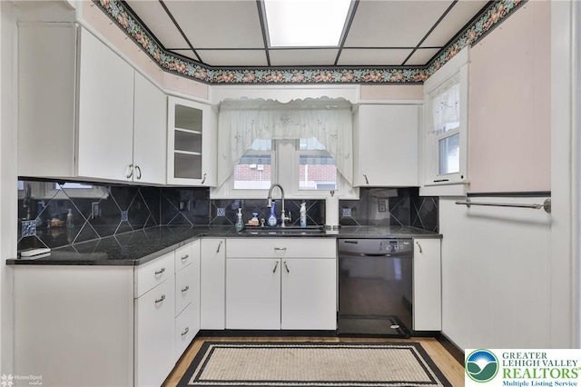 171 N New St, Nazareth Borough, PA 18064 - kitchen featuring black dishwasher, a sink, white cabinets, and backsplash