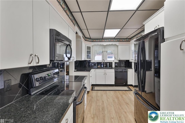 171 N New St, Nazareth Borough, PA 18064 - kitchen featuring black appliances, a sink, white cabinets, light wood finished floors, and dark countertops