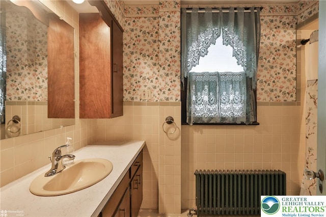 171 N New St, Nazareth Borough, PA 18064 - bathroom featuring radiator heating unit, wallpapered walls, tile walls, vanity, and a wainscoted wall
