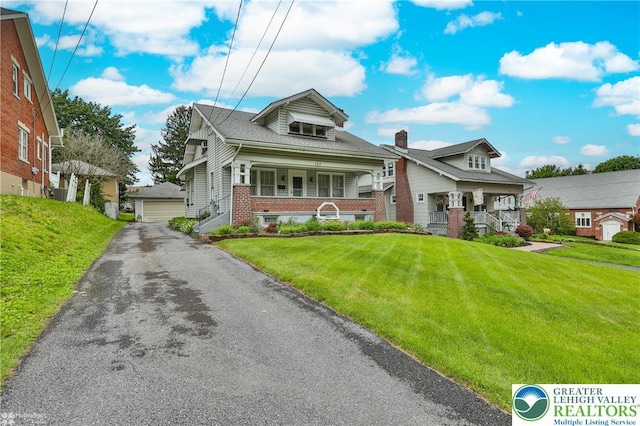 171 N New St, Nazareth Borough, PA 18064 - bungalow-style home with covered porch, a detached garage, a front yard, and brick siding
