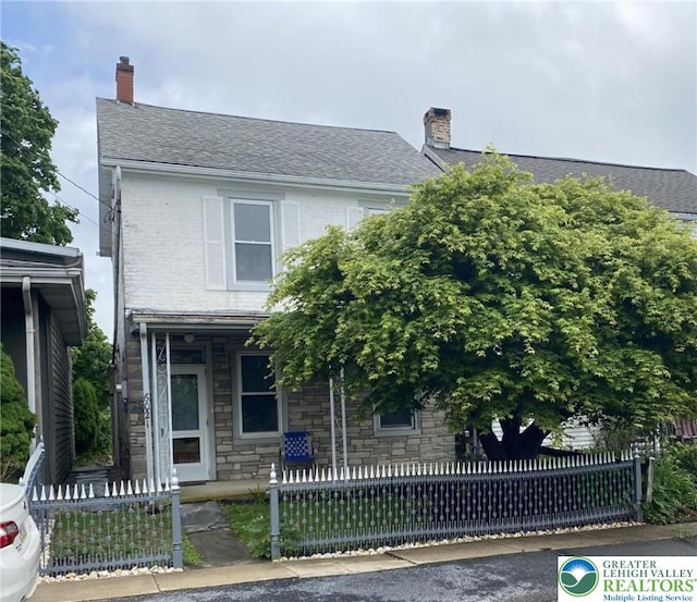 6021 Kings Hwy S, Upper Milford Twp, PA 18092 - view of front facade with a chimney, a fenced front yard, and roof with shingles