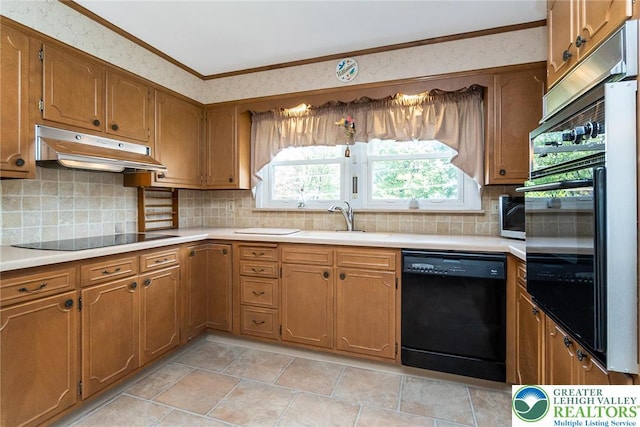 217 26th St, Allentown City, PA 18104 - kitchen with black appliances, under cabinet range hood, brown cabinets, light countertops, and a sink