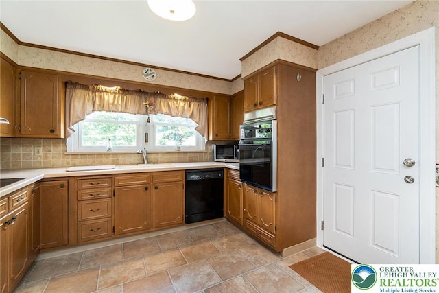 217 26th St, Allentown City, PA 18104 - kitchen featuring black appliances, a sink, brown cabinetry, backsplash, and light countertops