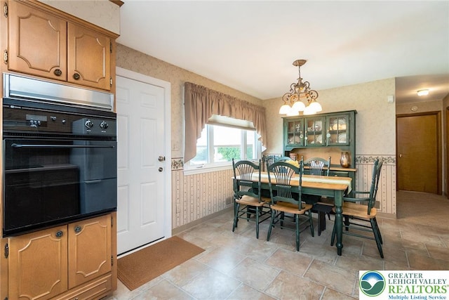 217 26th St, Allentown City, PA 18104 - dining room featuring wallpapered walls, a chandelier, baseboards, and a wainscoted wall