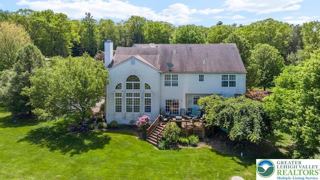 140 Birdie Way, Eldred Twp, PA 18058 - rear view of house featuring a wooden deck, a lawn, a chimney, stairway, and a view of trees