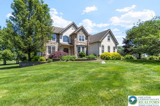 140 Birdie Way, Eldred Twp, PA 18058 - view of front of property featuring stone siding, a front lawn, and stucco siding