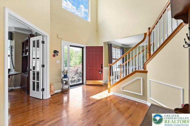 140 Birdie Way, Eldred Twp, PA 18058 - entrance foyer featuring hardwood / wood-style floors, healthy amount of natural light, stairs, and a high ceiling