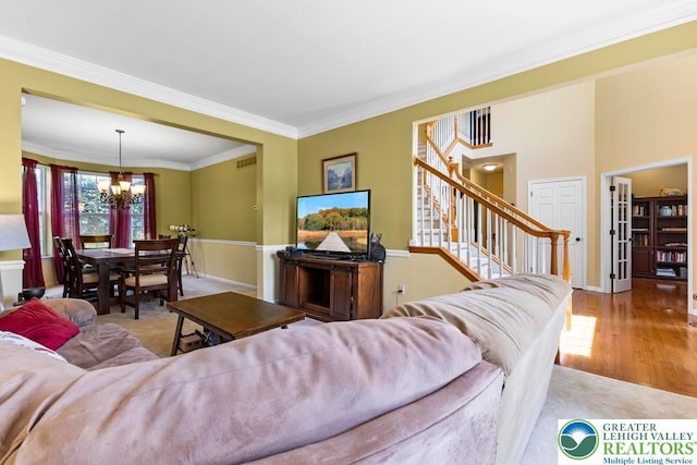 140 Birdie Way, Eldred Twp, PA 18058 - carpeted living area featuring a chandelier, stairway, ornamental molding, wood finished floors, and baseboards
