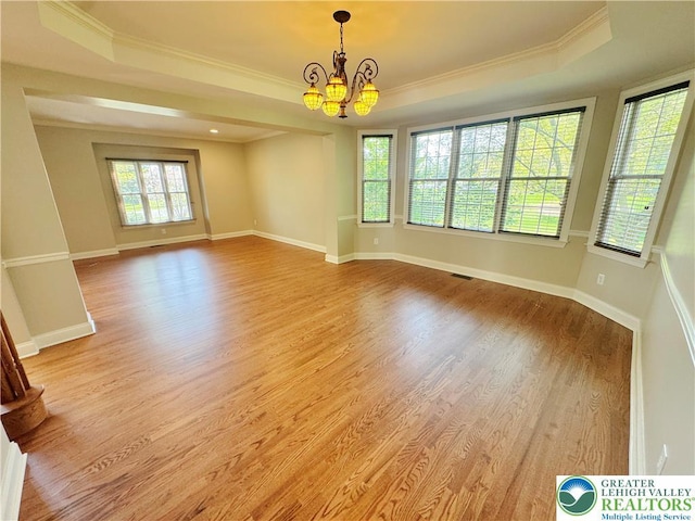 4620 Graystone Dr, Lower Nazareth Twp, PA 18064 - empty room with a tray ceiling, a chandelier, ornamental molding, and light wood finished floors