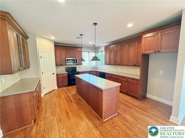 4620 Graystone Dr, Lower Nazareth Twp, PA 18064 - kitchen with black appliances, a kitchen island, backsplash, light wood-type flooring, and recessed lighting