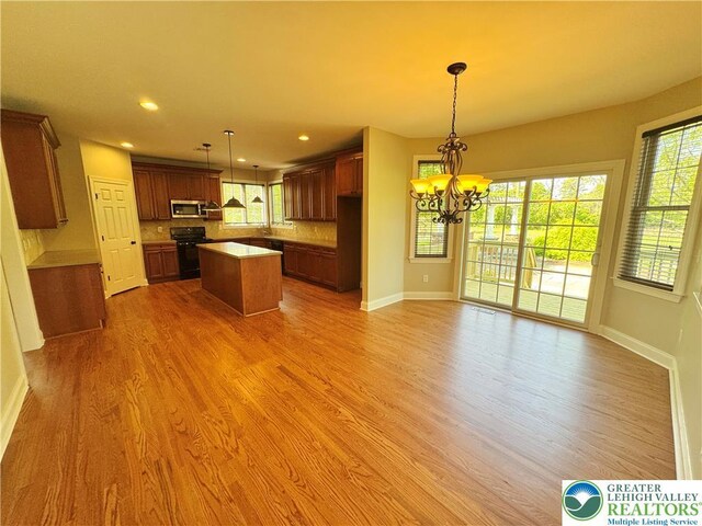 4620 Graystone Dr, Lower Nazareth Twp, PA 18064 - kitchen with black range with electric stovetop, stainless steel microwave, healthy amount of natural light, light wood-style flooring, and recessed lighting