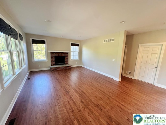 4620 Graystone Dr, Lower Nazareth Twp, PA 18064 - unfurnished living room with wood finished floors, a brick fireplace, and recessed lighting