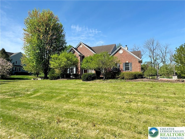 4620 Graystone Dr, Lower Nazareth Twp, PA 18064 - view of front of property featuring a front yard, brick siding, and a chimney