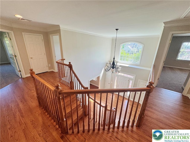 4620 Graystone Dr, Lower Nazareth Twp, PA 18064 - stairway featuring a chandelier, wood finished floors, and crown molding