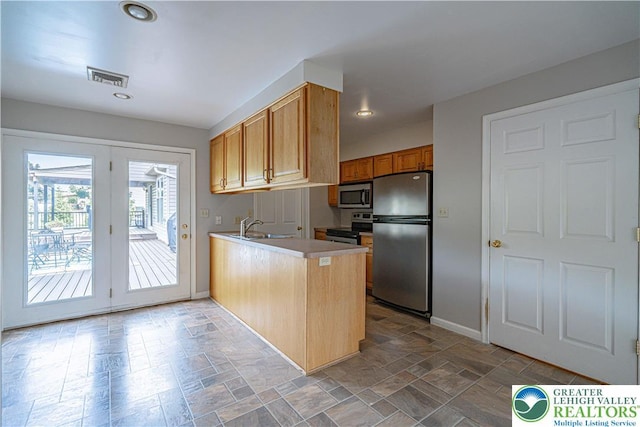 3624 Mcintosh Dr, North Whitehall Twp, PA 18069 - kitchen featuring appliances with stainless steel finishes, a peninsula, stone finish flooring, a sink, and recessed lighting
