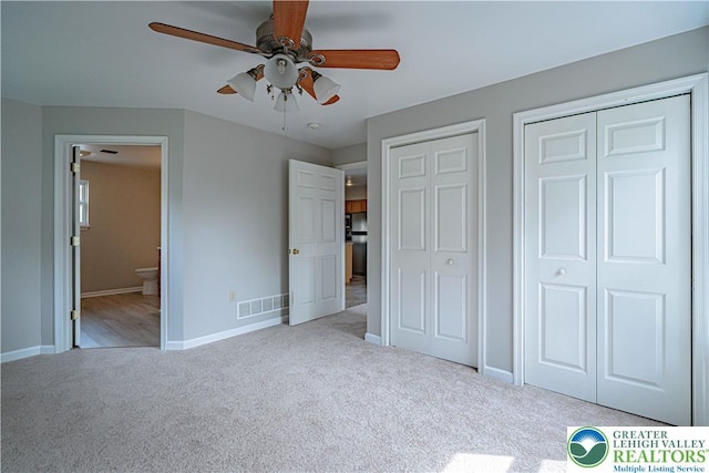 3624 Mcintosh Dr, North Whitehall Twp, PA 18069 - unfurnished bedroom with carpet, two closets, baseboards, ensuite bathroom, and ceiling fan