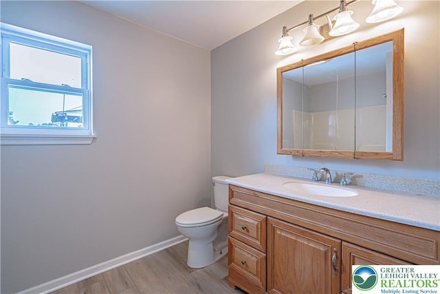 3624 Mcintosh Dr, North Whitehall Twp, PA 18069 - full bath with vanity, toilet, wood finished floors, and baseboards