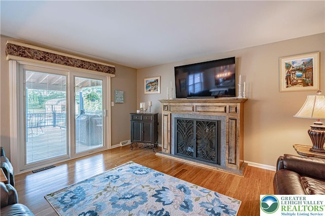 3624 Mcintosh Dr, North Whitehall Twp, PA 18069 - living area featuring wood finished floors, a fireplace, and baseboards