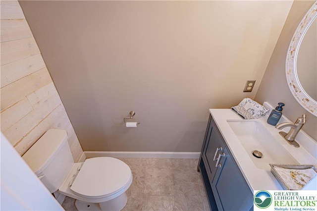 3624 Mcintosh Dr, North Whitehall Twp, PA 18069 - half bathroom featuring vanity, toilet, wooden walls, and baseboards