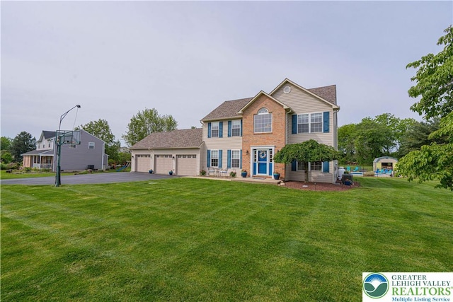 3624 Mcintosh Dr, North Whitehall Twp, PA 18069 - colonial home with driveway, a front yard, an attached garage, and brick siding