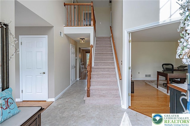 3624 Mcintosh Dr, North Whitehall Twp, PA 18069 - stairs with a towering ceiling, baseboards, and wood finished floors